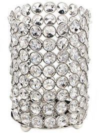 A silver candle holder filled with crystals on a white background.
