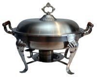 A stainless steel chafing dish with a lid and wooden handles on a white background.