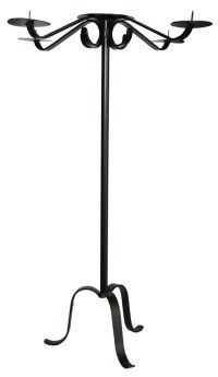 A black wrought iron candle holder with four candles on a white background.