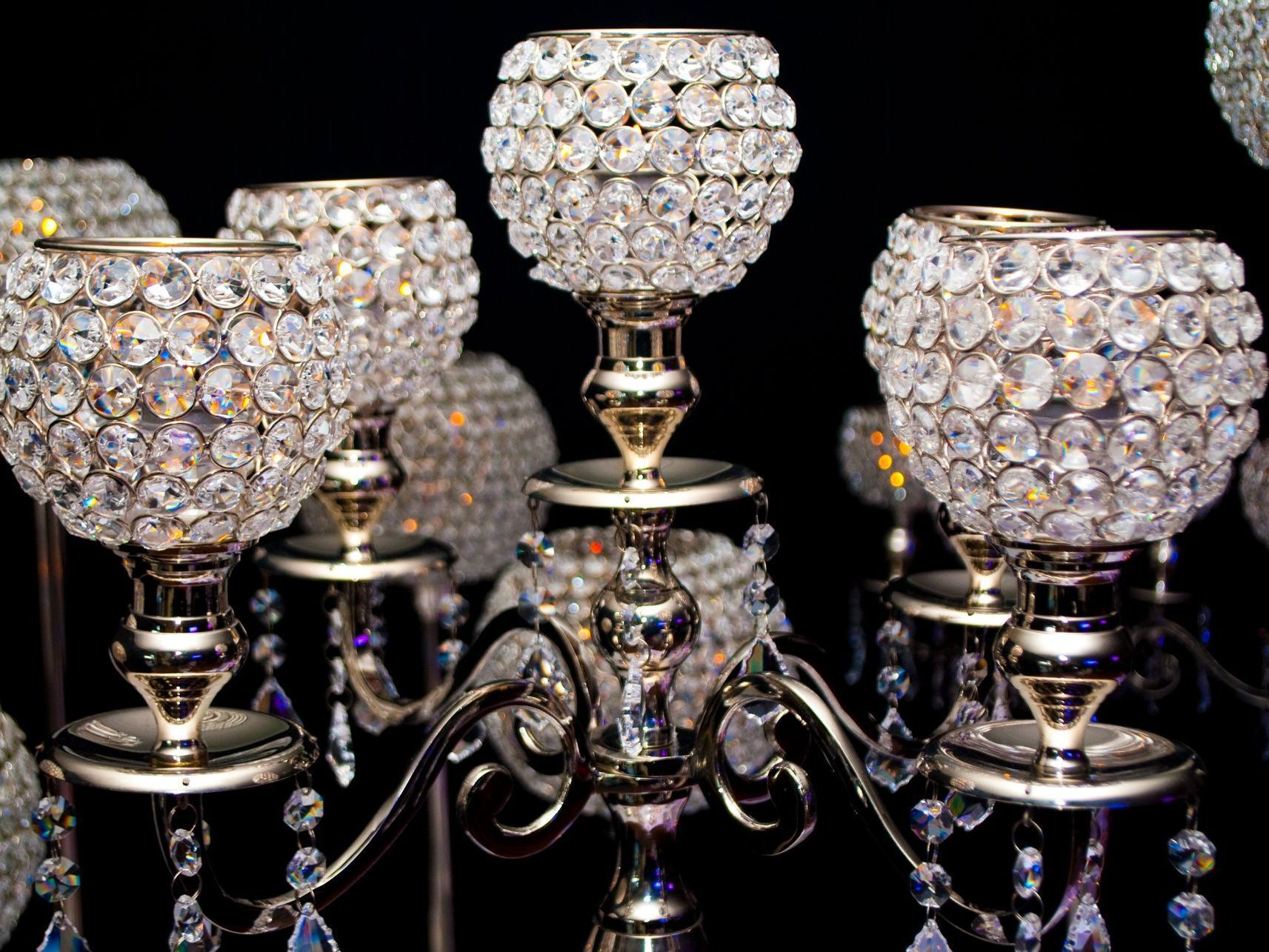 A group of crystal candle holders sitting on top of each other on a table.