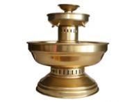 A brass fountain with two bowls and a lid on a white background.