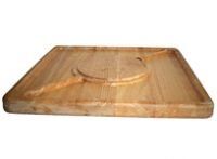 A wooden cutting board with a spoon and fork on it.