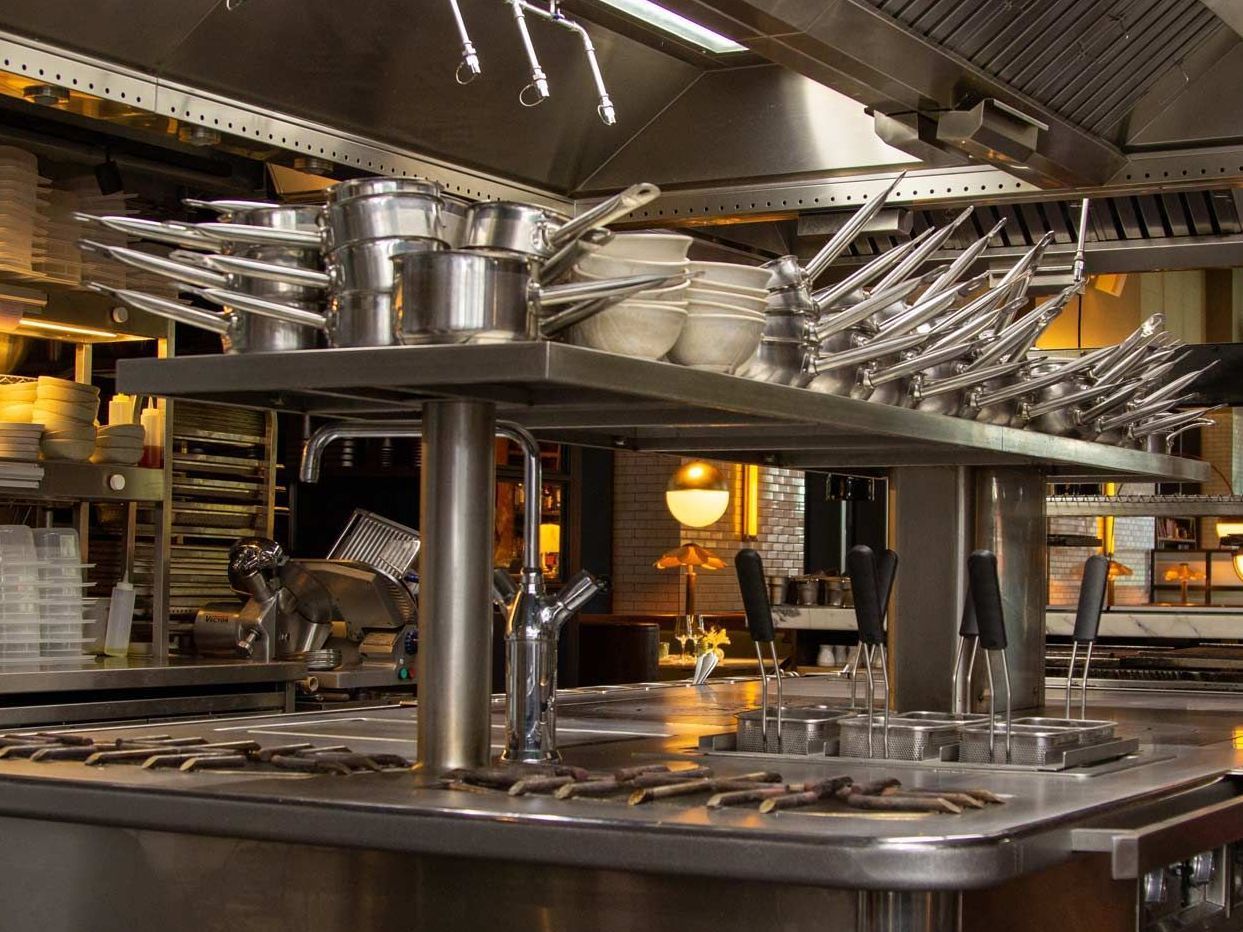 A kitchen with a lot of pots and pans on the counter