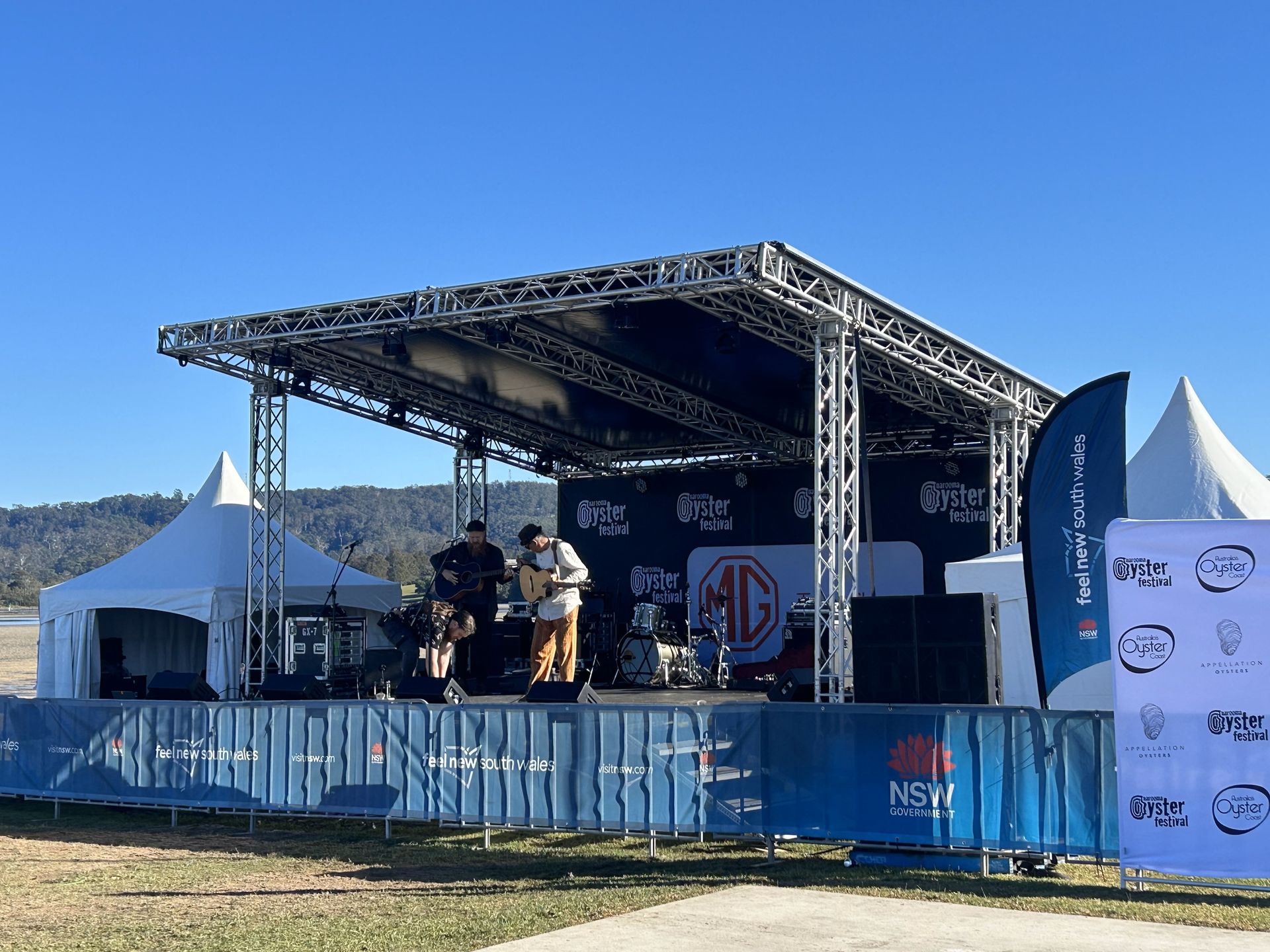 A row of red rope barriers along a red carpet