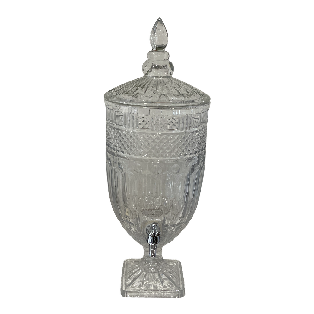 A clear glass drink dispenser with a lid and a tap on a white background.