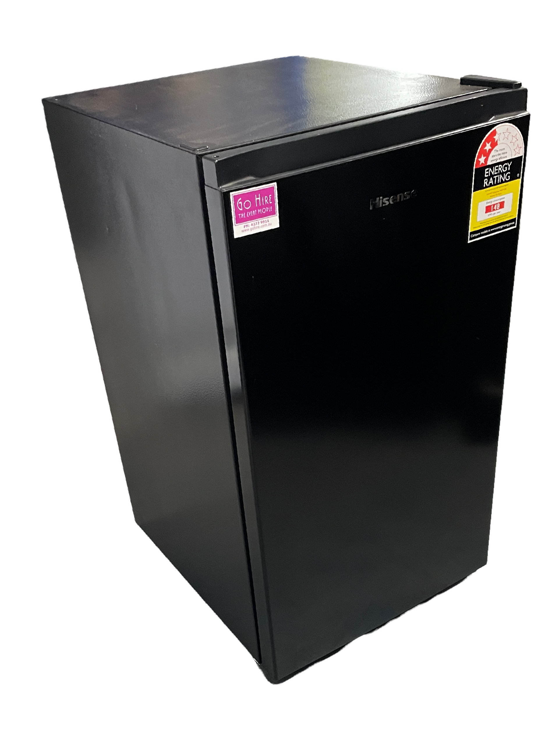 A small black refrigerator is sitting on a white surface.