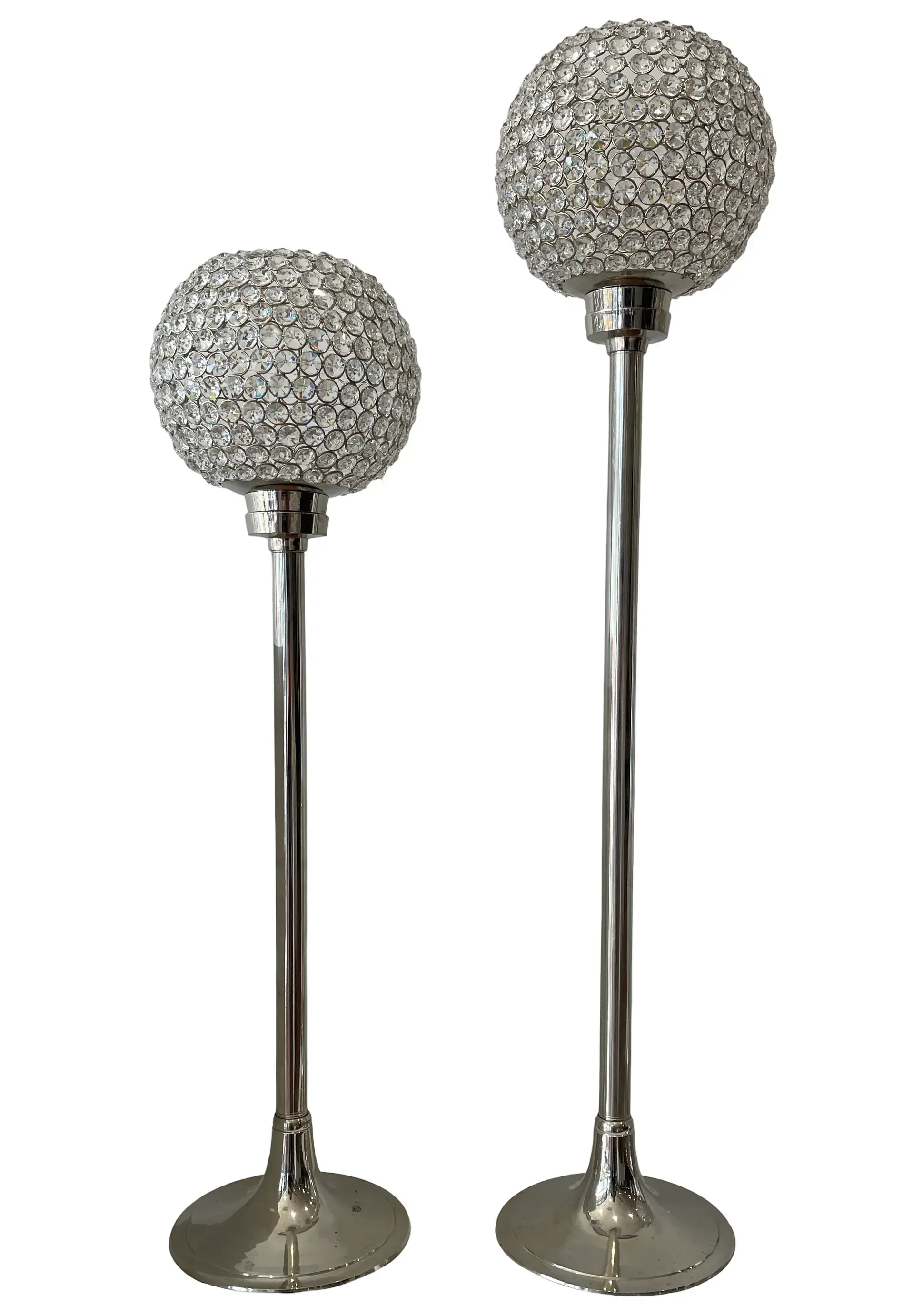 Two silver candle holders with crystal balls on them on a white background.