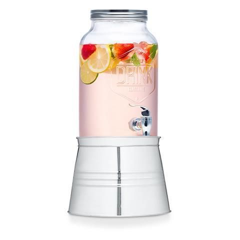 A drink dispenser with strawberries , lemons and limes in it