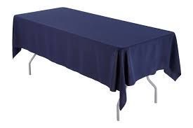 A long table with a blue tablecloth on it.