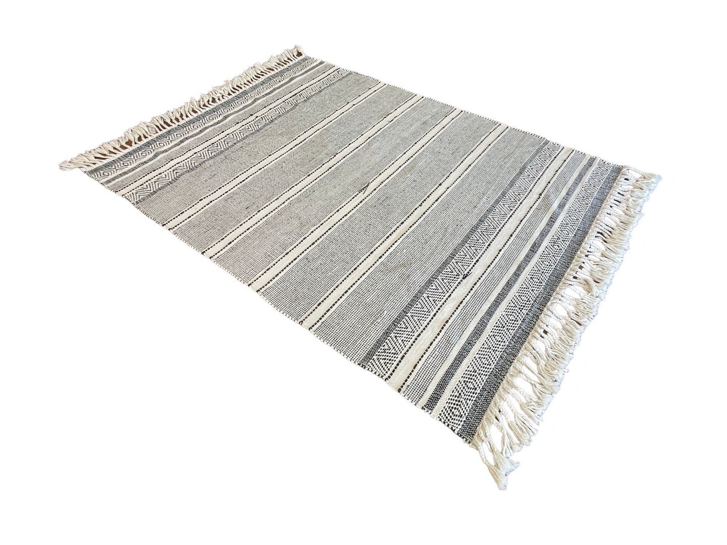 A black and white rug with fringe on a white background.