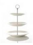 A white three tiered cake stand with four plates on a white background.