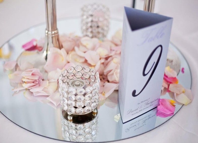 A table number 9 is sitting on a round mirror