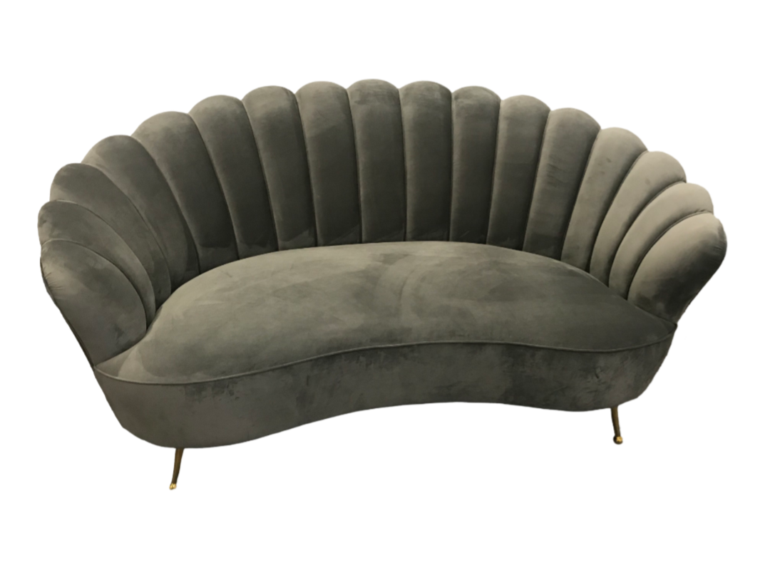 A green velvet couch with gold legs on a white background