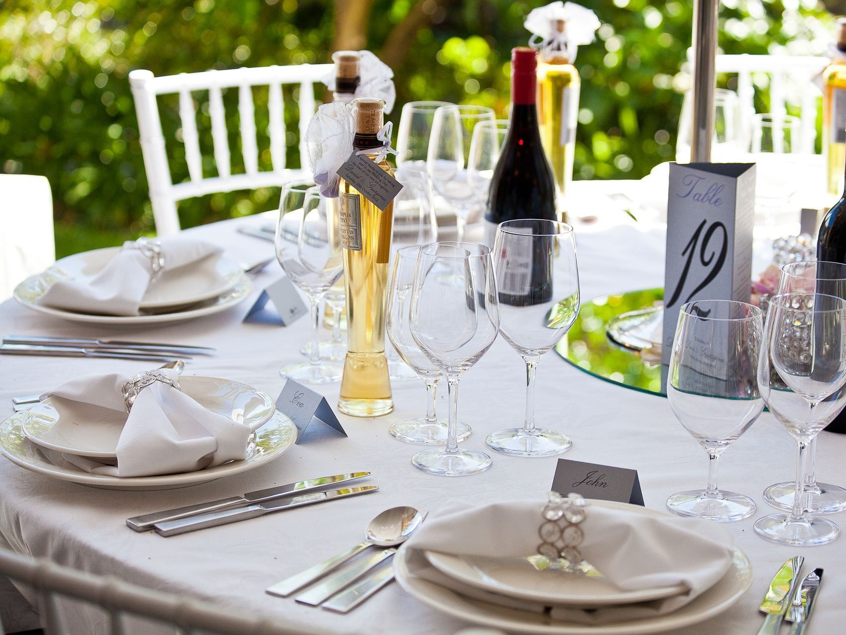 A table set for a wedding reception with wine glasses and plates
