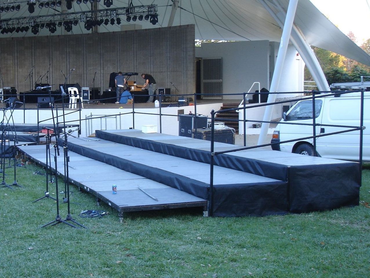A stage with stairs and a van parked in front of it