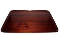 A wooden tray is sitting on a white surface.