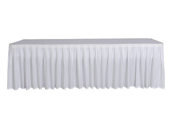 A white table with a white table skirt on it.