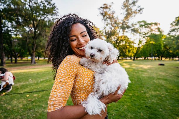 Beautiful woman and her dog in a park. 