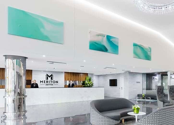 A Hotel Lobby With a Couch and Chairs and a Reception Desk — Gold Coast Printing & Framing in Burleigh Heads, QLD