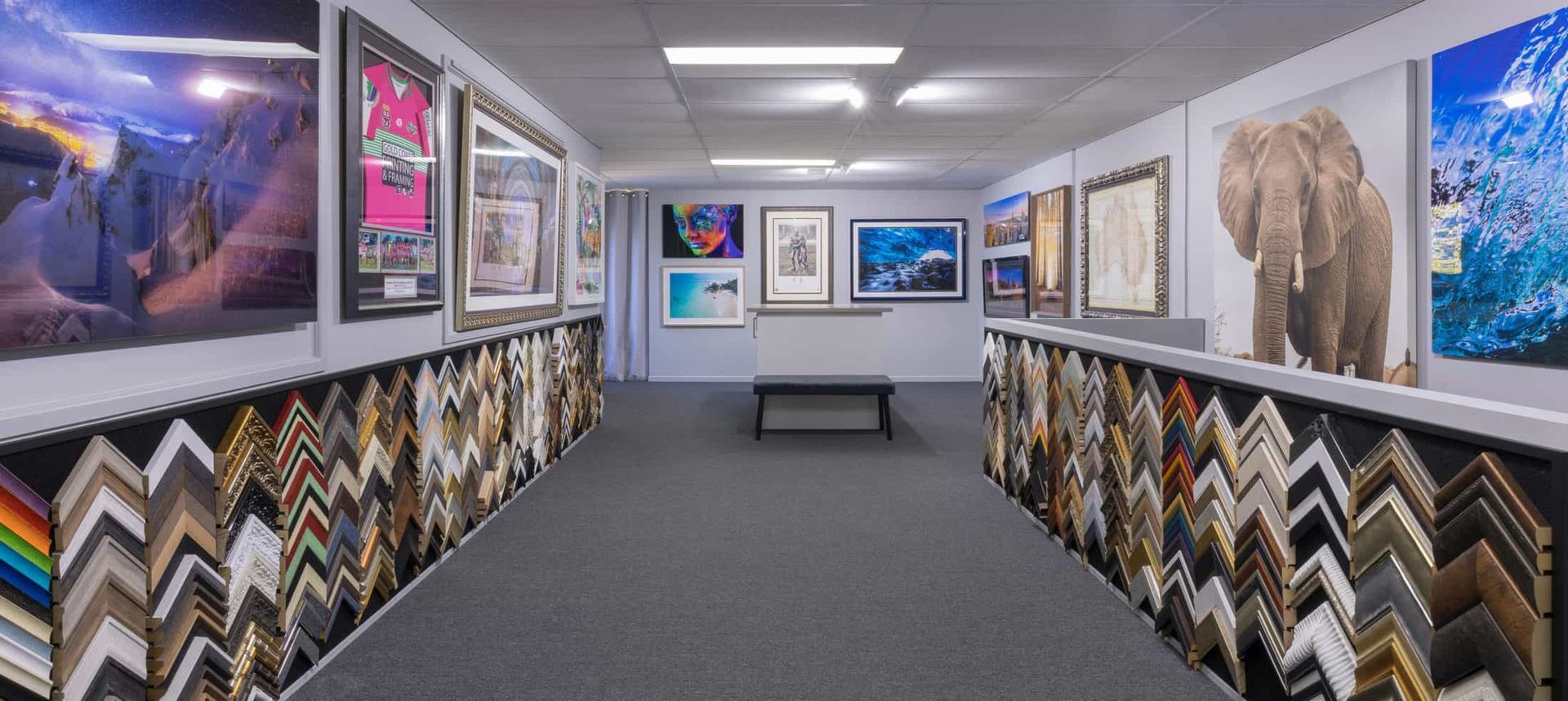 A Long Hallway Filled With Lots of Framed Pictures on the Walls — Gold Coast Printing & Framing in Burleigh Heads, QLD