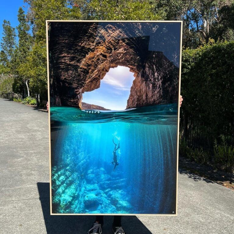 A Person is Holding a Picture of a Cave— Gold Coast Printing & Framing in Burleigh Heads, QLD