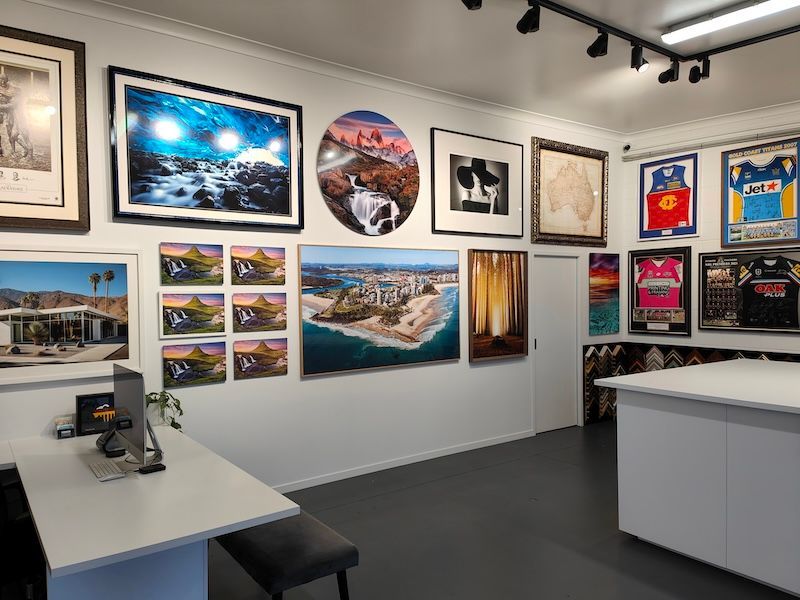 A Room Filled With Paintings on the Wall and a Table — Gold Coast Printing & Framing in Burleigh Heads, QLD