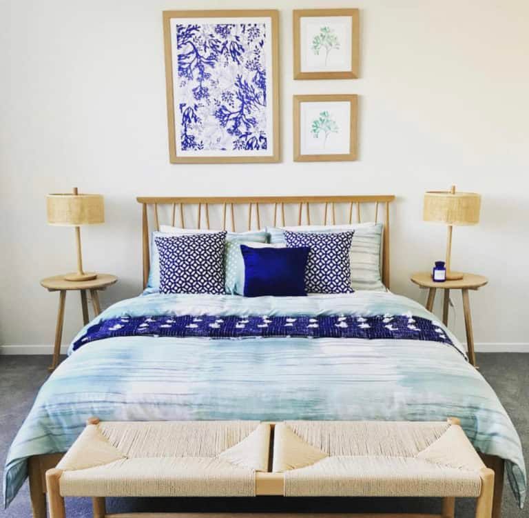 A Bedroom With a Bed With a Blue Comforter and Blue Pillows — Gold Coast Printing & Framing in Burleigh Heads, QLD