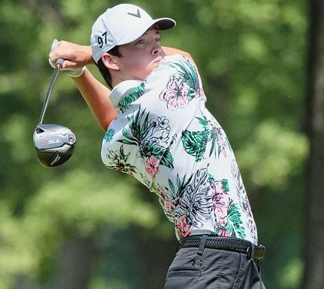 A man and a woman are playing golf on a golf course.