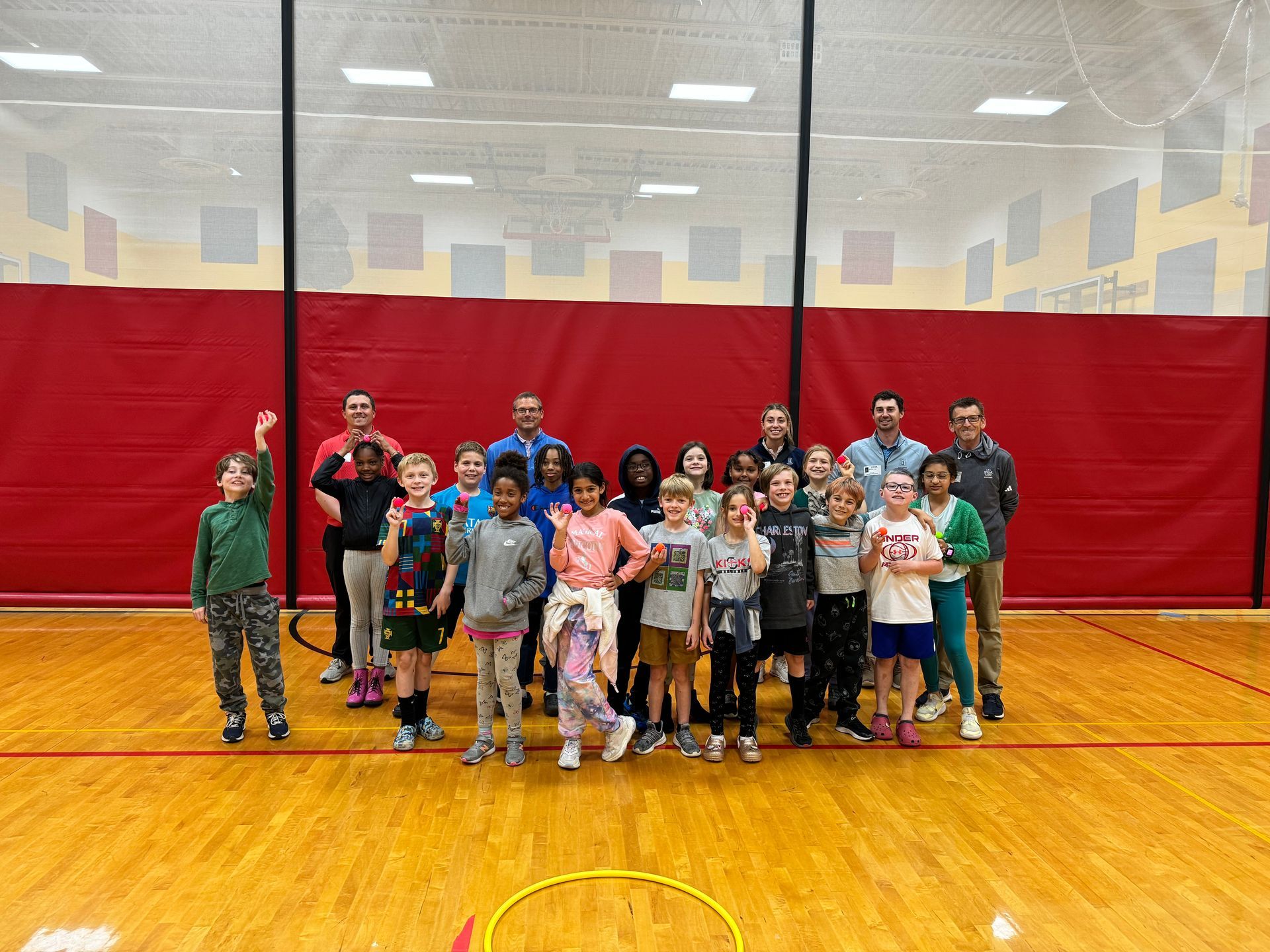 A group of children are posing for a picture in a gym.