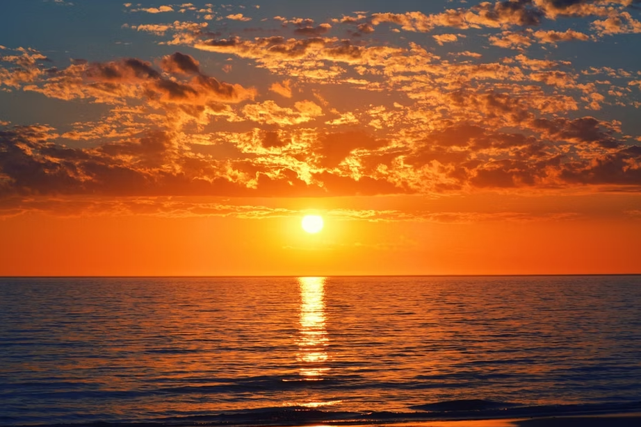 The sun is setting over the ocean.