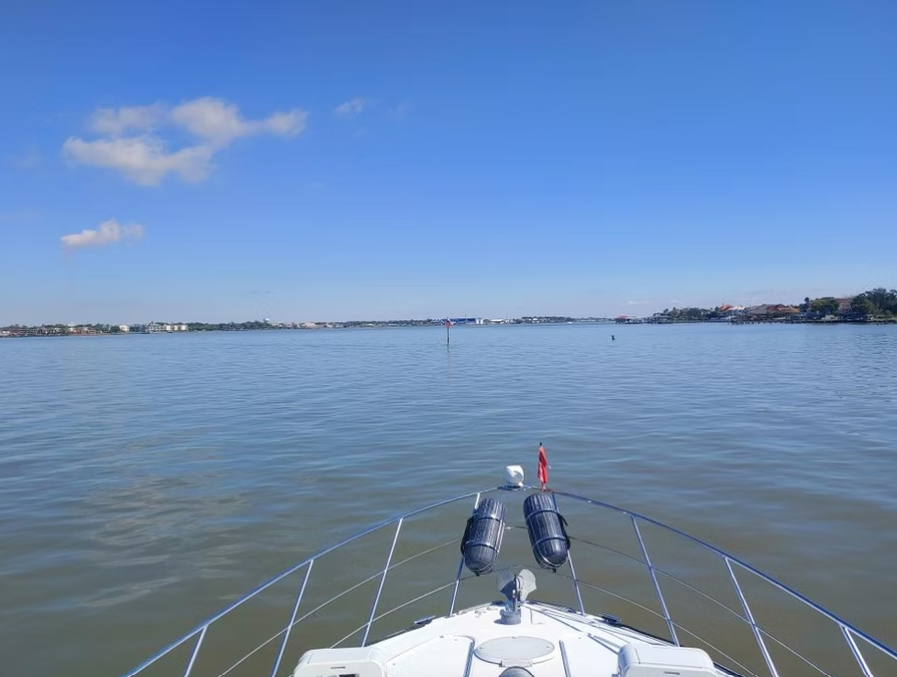 A boat is floating on top of a large body of water.