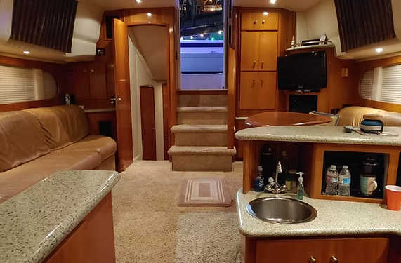 The inside of a boat with a sink and stairs