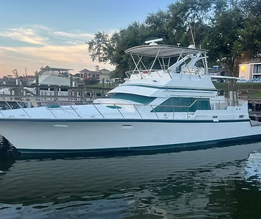 A large white boat is floating on top of a body of water.