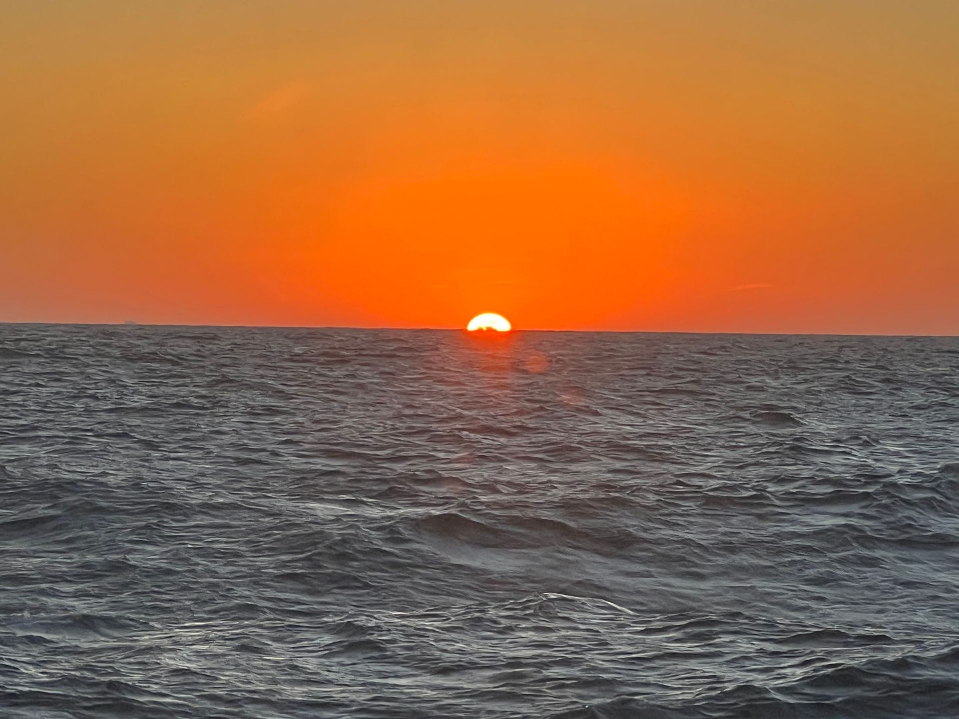 The sun is setting over the ocean.