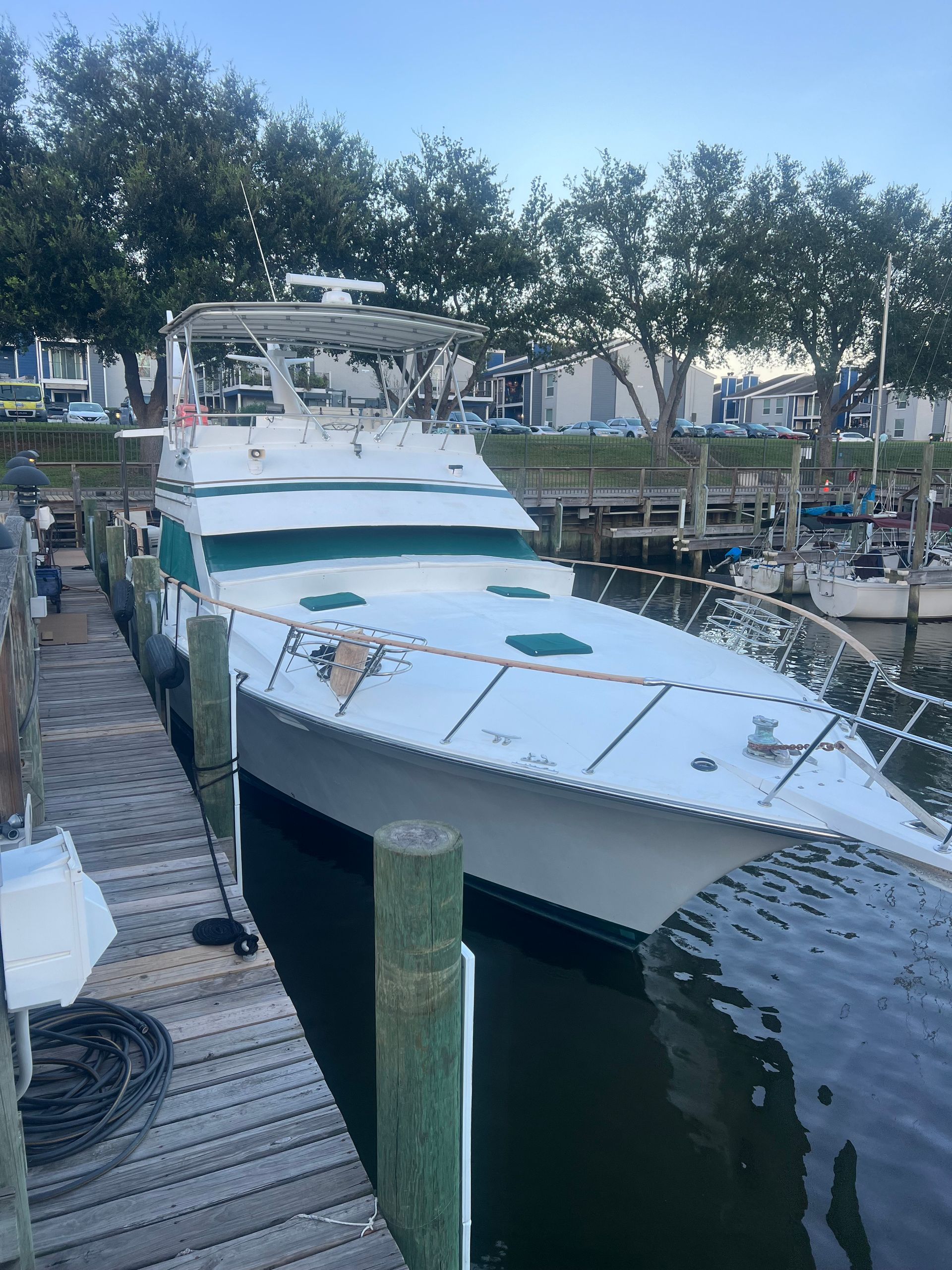 A large white boat is docked at a dock.