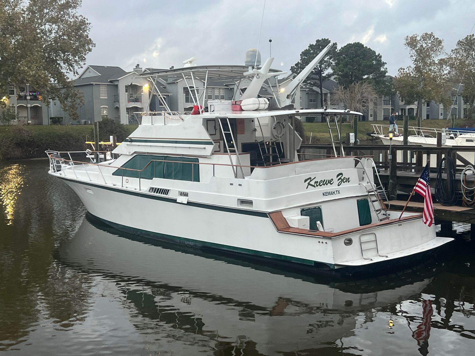 A large white boat is docked at a dock.
