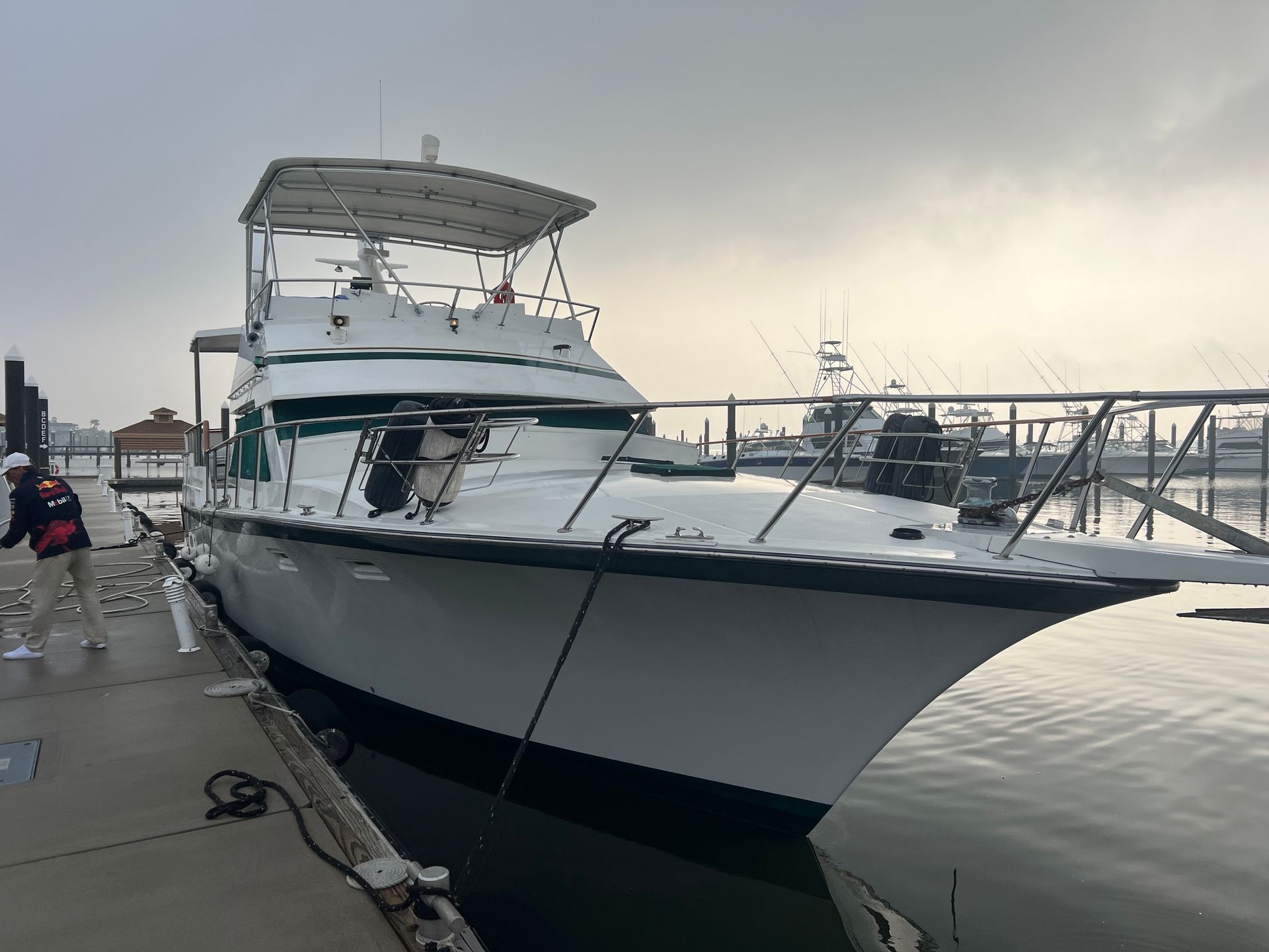 A large white boat is docked at a dock.