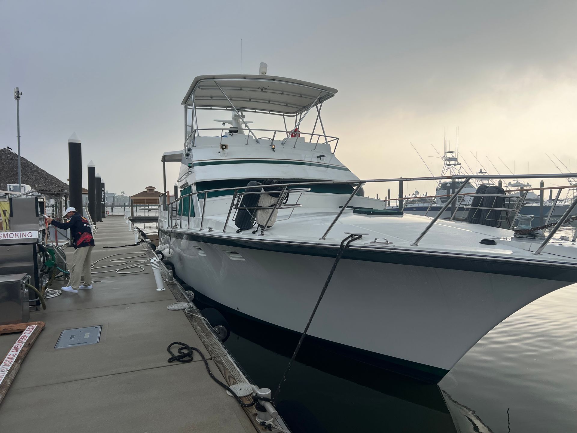 A large white boat is docked at a dock.