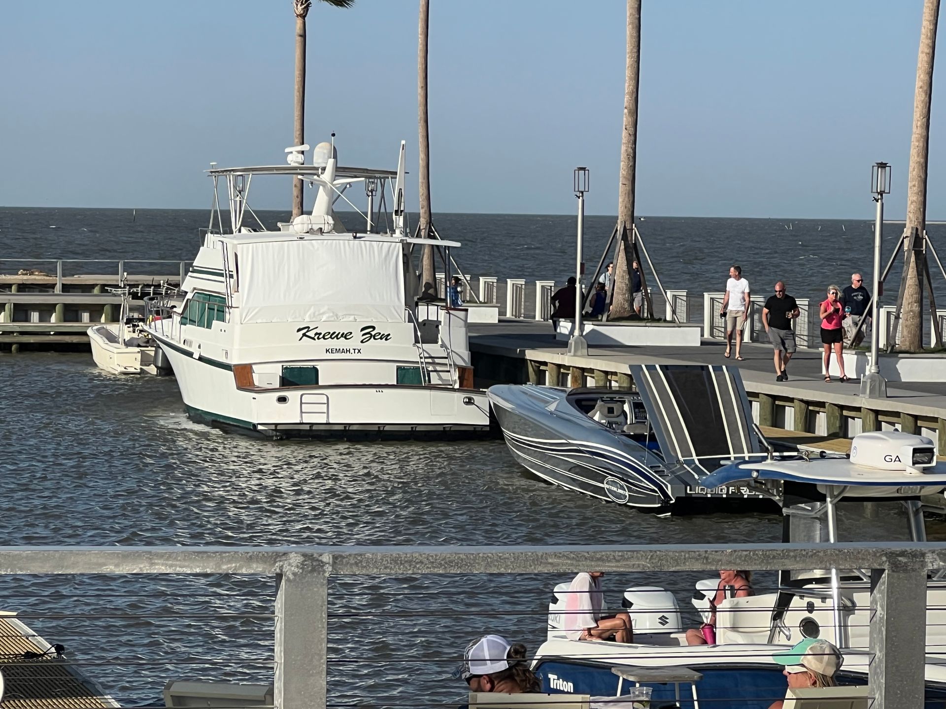 A boat with the word riviera on the back is docked at a dock