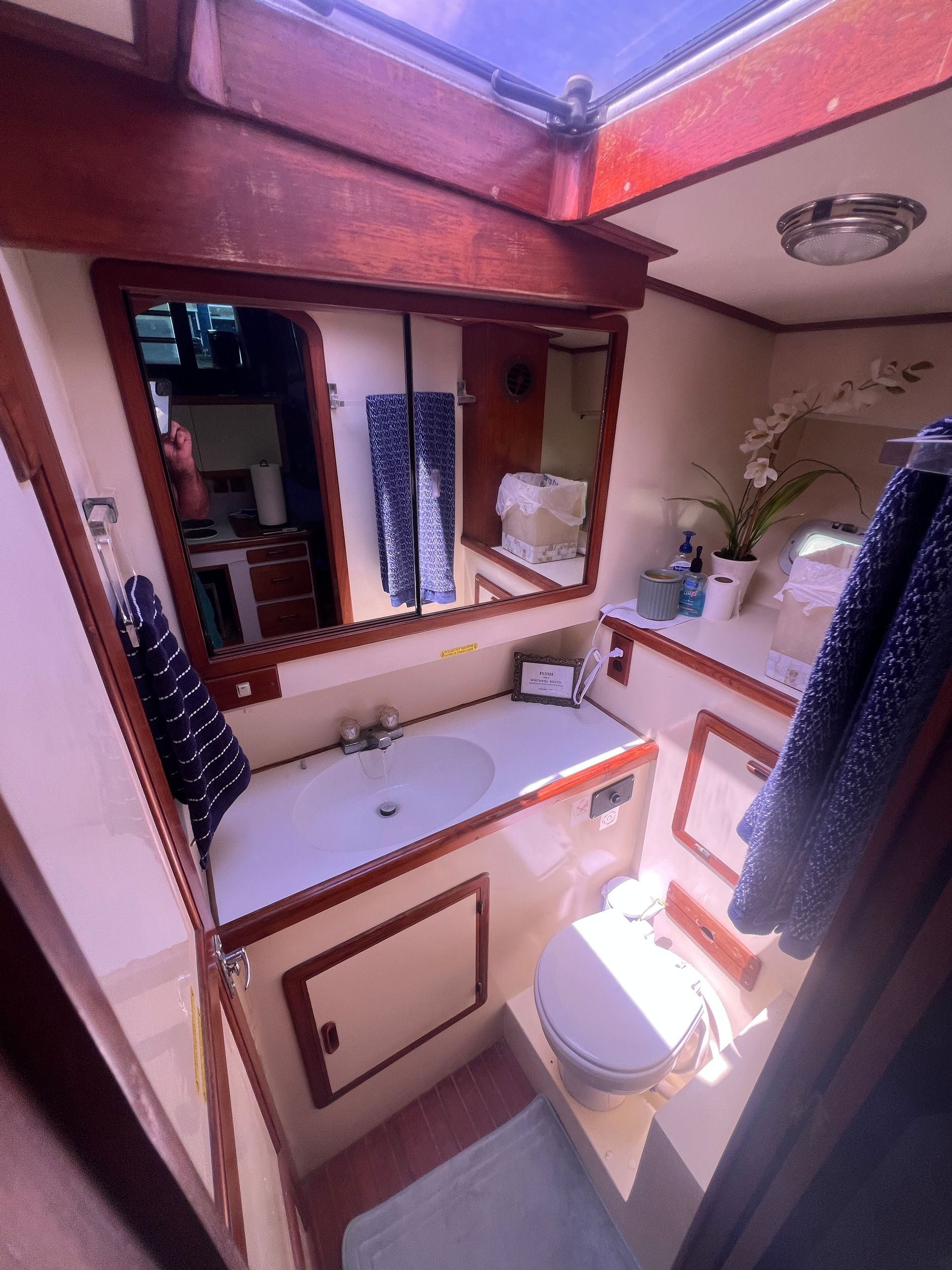 A bathroom on a boat with a sink and toilet