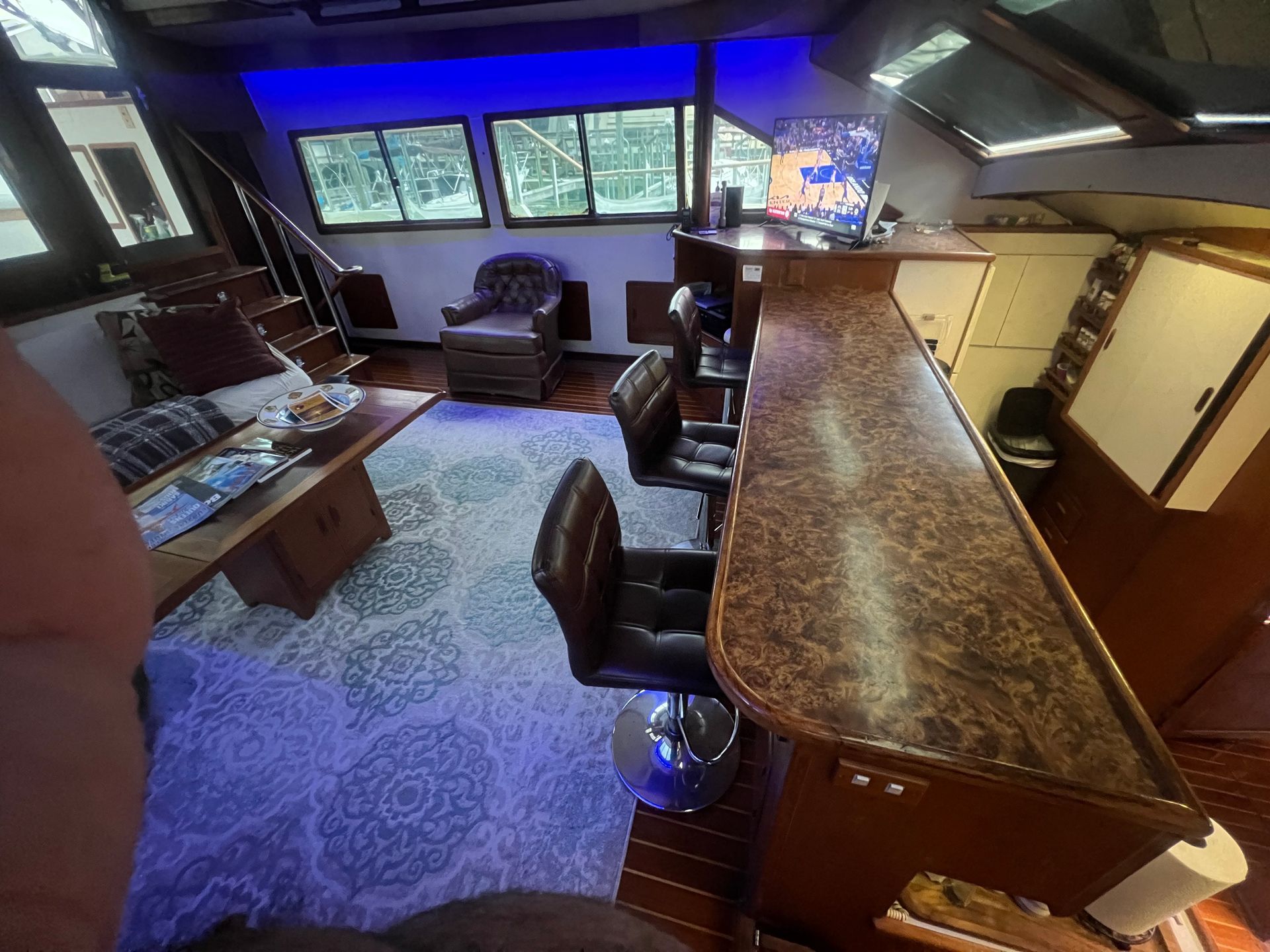 A man taking a picture of a living room on a boat