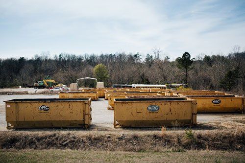 yellow dumpsters in a lot