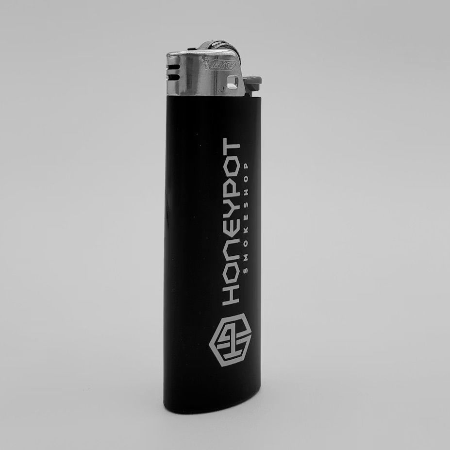 A black disposable cigarette lighter with a silver metallic top and a white logo reading 