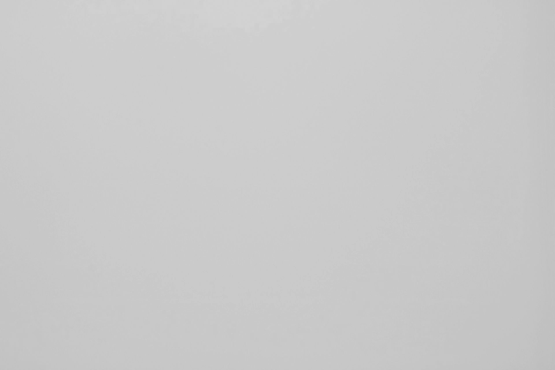 A plain, solid light gray background.