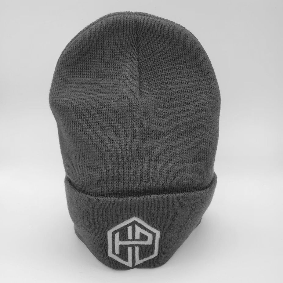 A dark gray knit beanie with a white embroidered hexagonal logo featuring the letters HP on the front cuff.