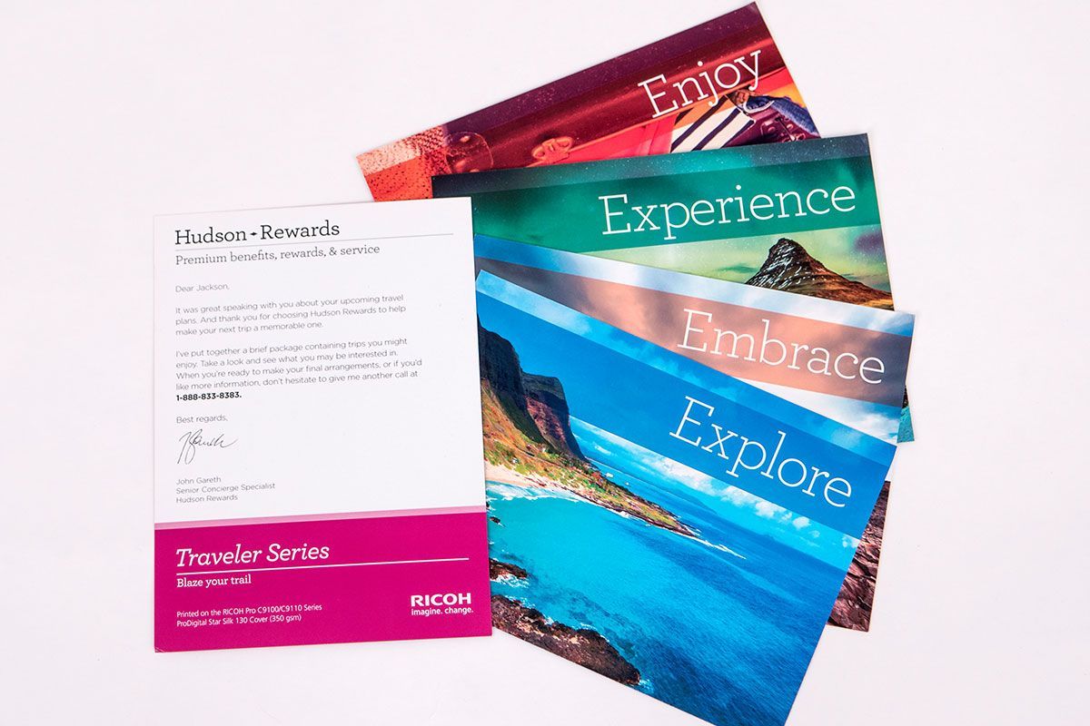 A stack of postcards with the words enjoy experience and explore on them
