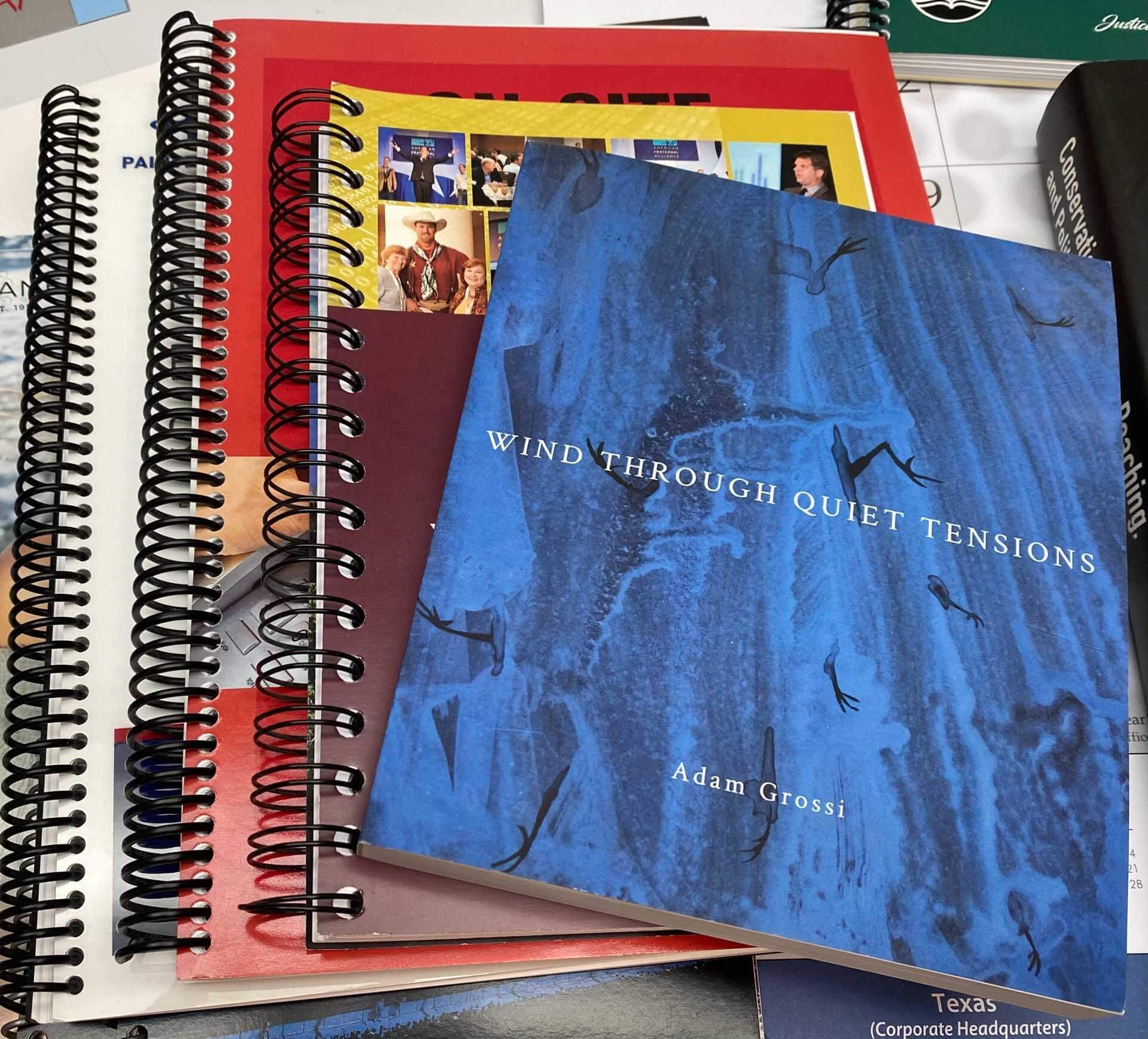 A spiral bound book titled wind through quiet tensions