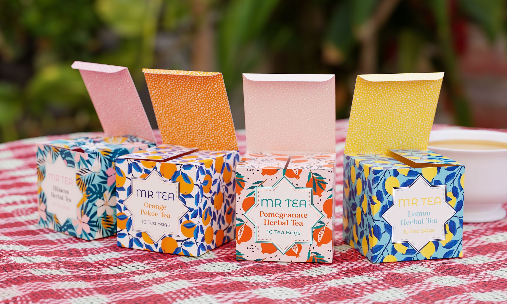 Three boxes of tea are sitting on a table with their lids open.