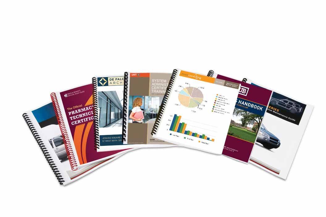 A bunch of notebooks are stacked on top of each other on a white background.