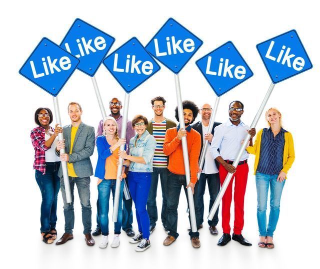 A group of people are holding blue signs that say like